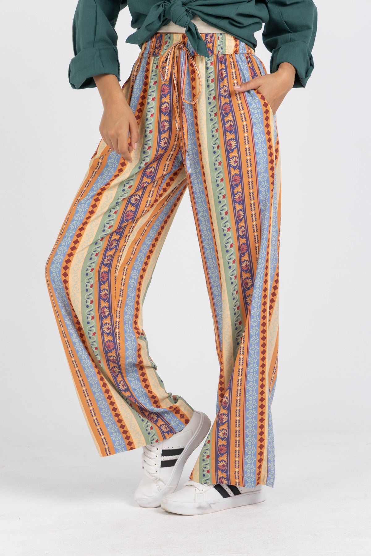 Image of Person wearing colorful striped pants with a white background